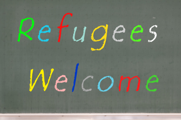 "Refugees Welcome" in rainbow letters on a blackboard.
